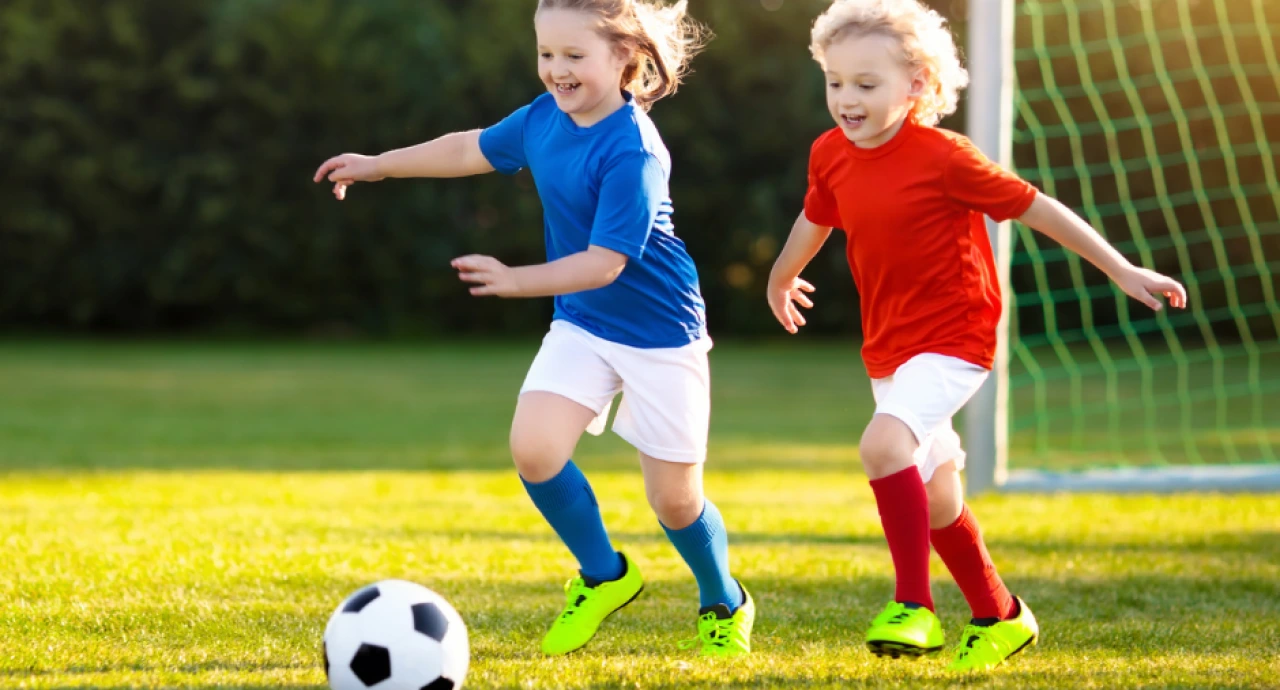 Young children playing football